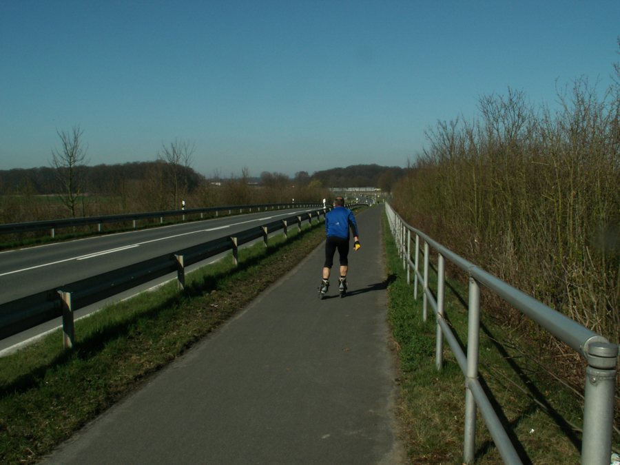 Inline-Skater auf asphaltiertem Weg